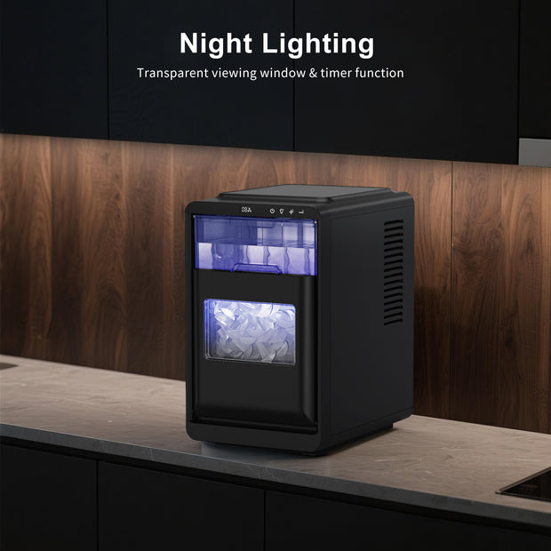 Black ice maker with transparent window on a kitchen counter, featuring night lighting and timer function.